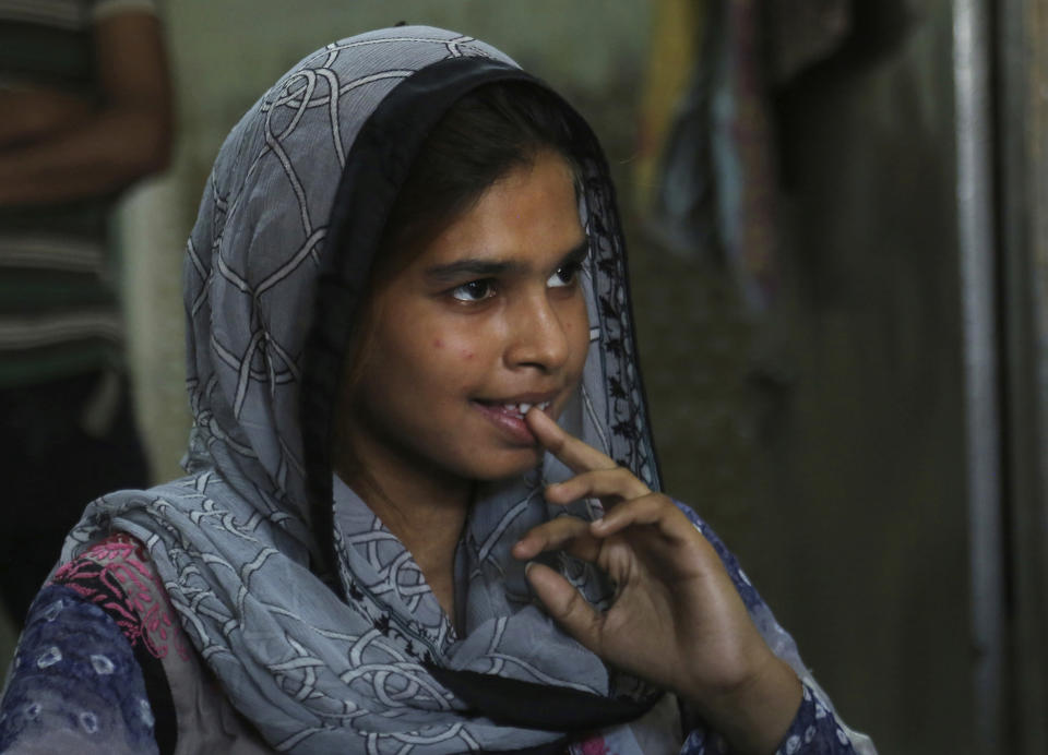 In this April 14, 2019 photo, Muqadas Ashraf speaks to The Associated Press in Gujranwala, Pakistan. Muqadas Ashraf was just 16 when her parents married her off to a Chinese man who had come to Pakistan looking for a bride. Less than five months later, Muqadas is back home in Pakistan, pregnant and seeking a divorce from a husband she says was abusive. (AP Photo/K.M. Chaudary)