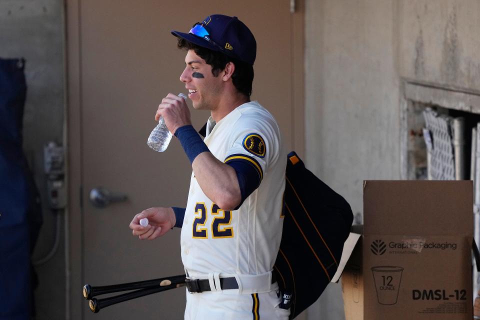 Milwaukee Brewers' Christian Yelich pauses in the dugout prior to a spring training baseball game against the San Diego Padres Thursday, March 23, 2023, in Phoenix. (AP Photo/Ross D. Franklin)