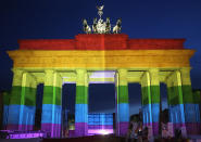 <p>The Brandenburg Gate is seen with a rainbow flag projected onto it during a vigil for victims of a shooting at a gay nightclub in Orlando, Florida nearly a week earlier, in front of the United States embassy on June 18, 2016 in Berlin, Germany. (Adam Berry/Getty Images) </p>