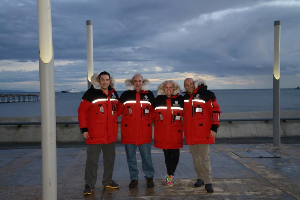 Diego Delgado, Dale Shippam, Heather Ross and Michel White smile in their Outdoor Survival Canada coats.
