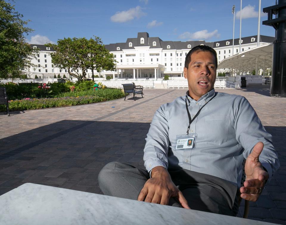 Rodney Gutierrez, director of sales, talks about the World Equestrian Center on May 20 on the patio of one of the restaurants, Viola & Dot's Italian Kitchen & Pizzeria. The hotel is shown behind him.