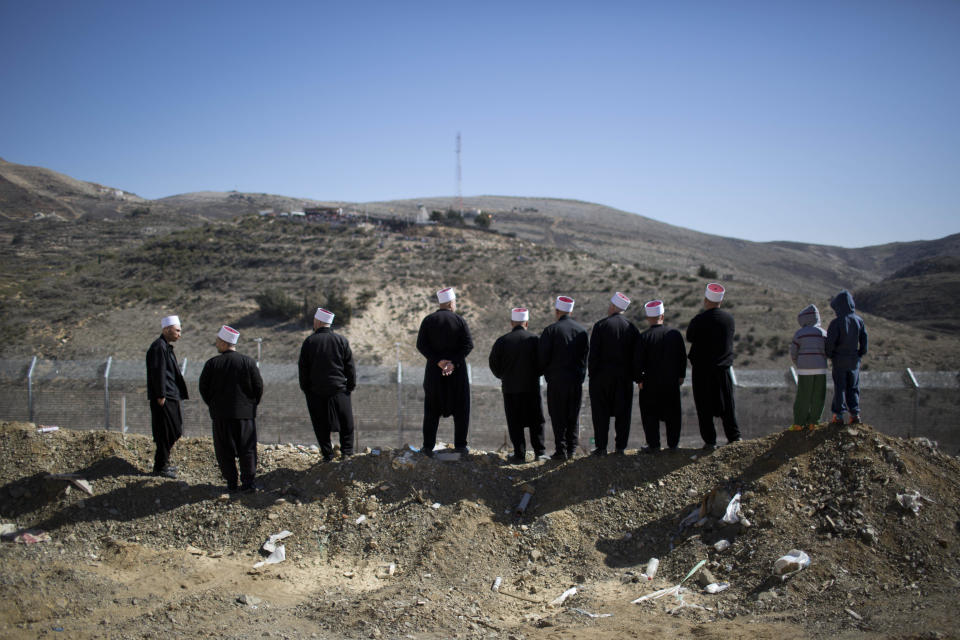 FILE - In this Feb. 14, 2014, file photo, Druze protesters participate in a rally in Majdal Shams in the Golan Heights, demanding the return of the territory captured by Israel in 1967, near the Syrian border. The annual demonstration protests the 1981 Israeli law in which the Jewish state annexed the strategic plateau it captured from Syria in 1967. (AP Photo/Oded Balilty, File)