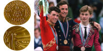 <p>The Calgary 1988 medal features the profiles of an athlete with an olive wreath and an Indian with a headdress.<br> (IOC photo; Medalists for Men’s Figure Skating, Canadian Brian Orser, American Brian Boitano, and Ukrainian Viktor Petrenko/photo by Daniel Janin/AFP/Getty Images) </p>