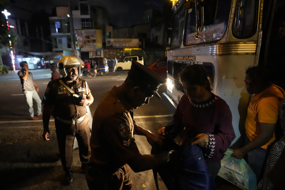 Sri Lankan police officers search a commuter during a search operation against narcotics in Colombo, Sri Lanka, Thursday, Jan. 18, 2024. (AP Photo/Eranga Jayawardena)