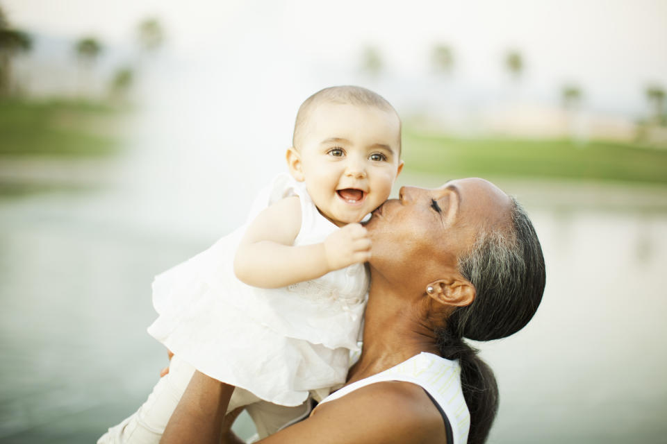 Grandma kissing baby