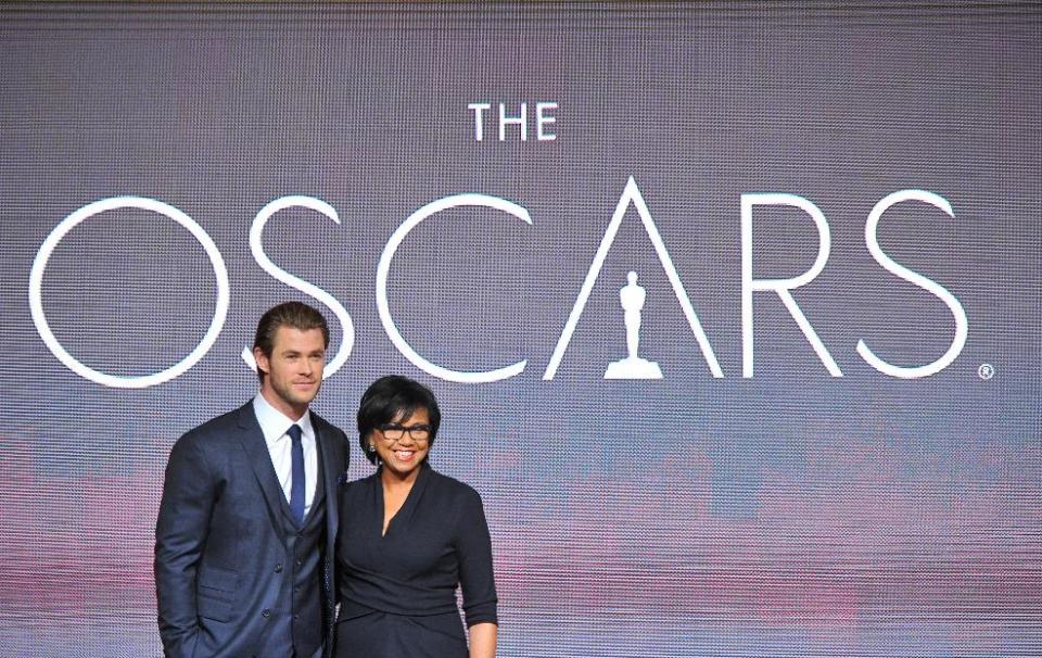 FILE - In this Thursday, Jan. 16, 2014 file photo, Chris Hemsworth, left, and President of the Academy Cheryl Boone Isaacs pose at the 86th Academy Awards nomination ceremony in Beverly Hills, Calif. Isaacs has become the third female Academy of Motion Picture Arts and Sciences president and the first ever African-American head of the organization. The 86th Annual Academy Awards will take place on Sunday, March 2, 2014, at the Dolby Theatre in Los Angeles. (Photo by Vince Bucci/Invision/AP, File)