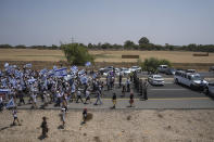 Israeli police officers try to block supporters and family members of Israeli soldier Hadar Goldin, killed during the 2014 conflict in the Gaza Strip, from marching towards the Gaza border near Kibbutz Yad Mordechai, southern Israel Friday, Aug. 5, 2022. The protesters call for the return of Goldin's and Israeli civilians held by Gaza's Hamas rulers back to Israel. The demonstration comes as Israel has closed all roads along Gaza border since Tuesday and sent reinforcements for fears of attacks from Gaza following the arrest of a senior Palestinian militant in the West Bank. (AP Photo/Ariel Schalit)
