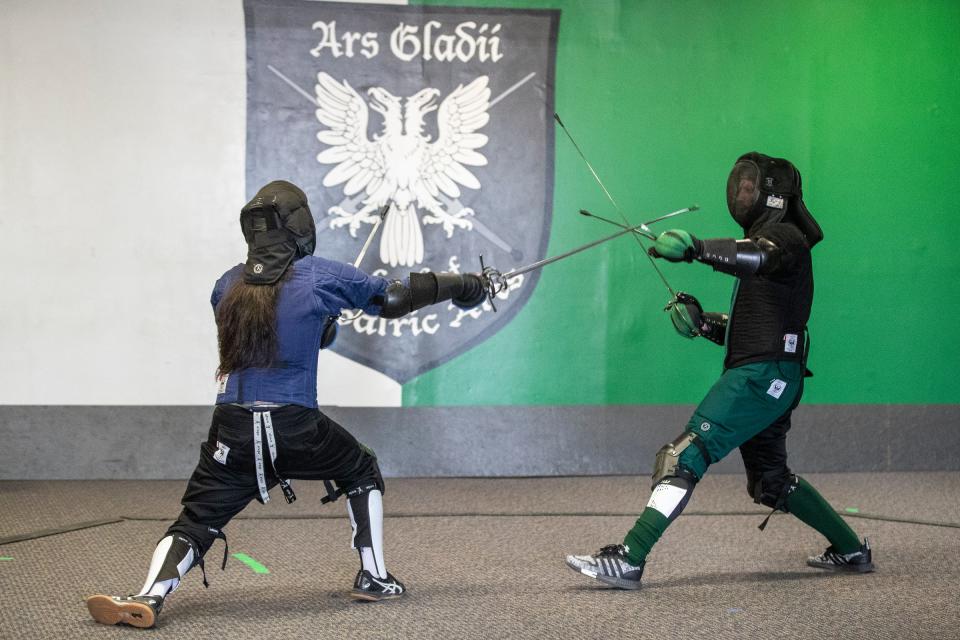Brandon Nguyen, left, and Jason Roggenbuck demonstrate a rapier and dagger fight at Ars Gladii School of Chivalric Arts in Garden City on Saturday, April 29, 2023.