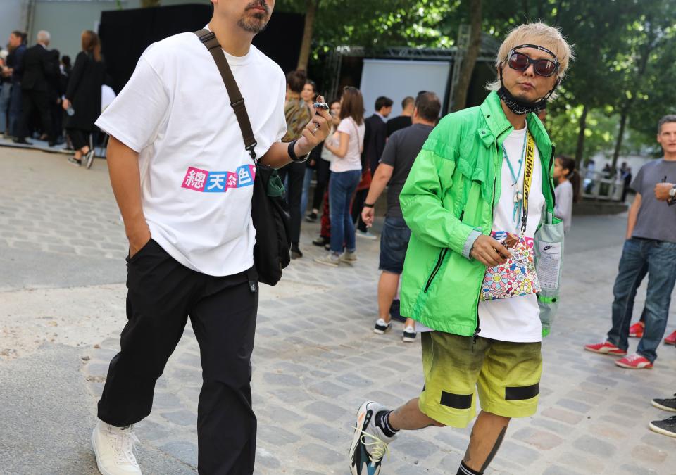<h1 class="title">In a Nike jacket with an Off-White x Takashi Murakami bag, <em>right</em></h1><cite class="credit">Photographed by Phil Oh</cite>
