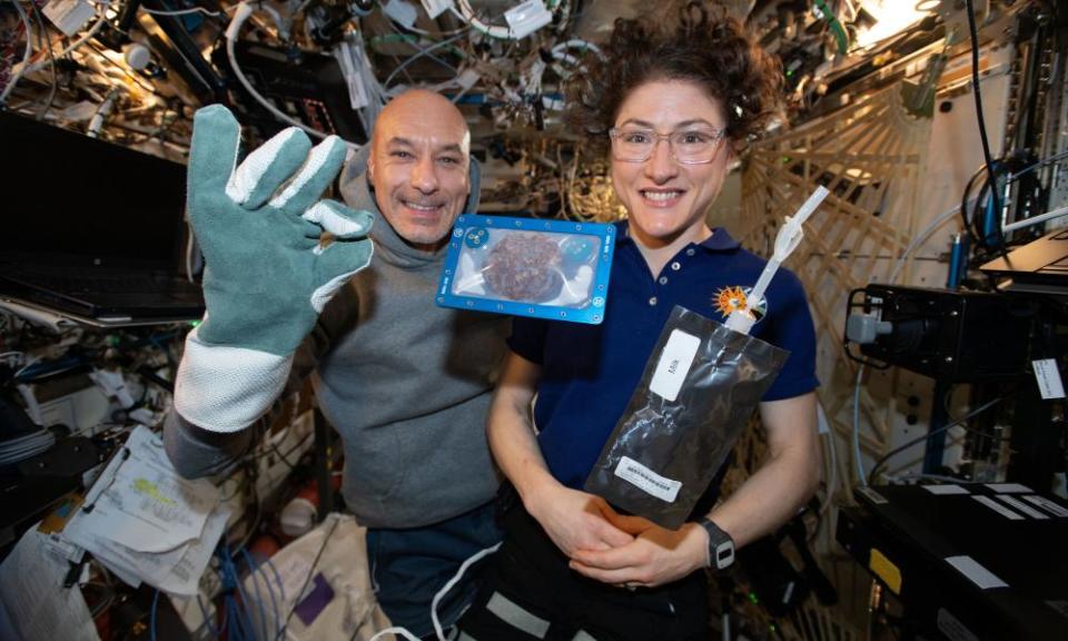 The International Space Station (ISS) commander, Luca Parmitano, and astronaut Christina Koch with milk and cookies on board the ISS