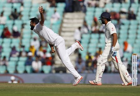 South Africa's Imran Tahir (L) bowls past India's Rohit Sharma during the second day of their third test cricket match in Nagpur, India, November 26, 2015. REUTERS/Amit Dave