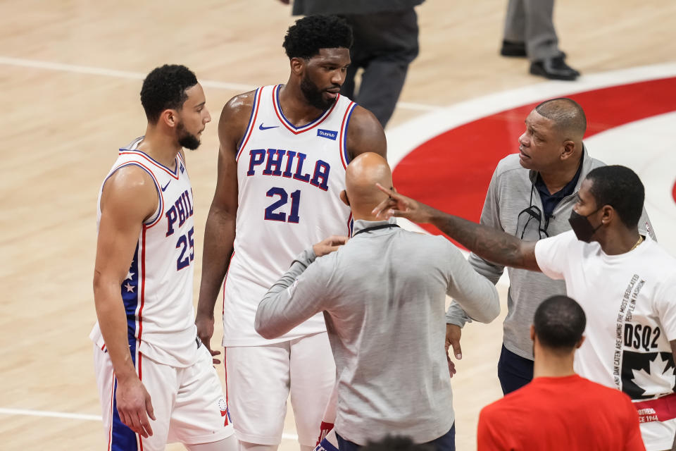 Jun 11, 2021; Atlanta, Georgia, USA; Philadelphia 76ers center Joel Embiid (21) and guard Ben Simmons (25) react with head coach Doc Rivers (right) after the 76ers defeated the Atlanta Hawks in game three in the second round of the 2021 NBA Playoffs at State Farm Arena. Mandatory Credit: Dale Zanine-USA TODAY Sports