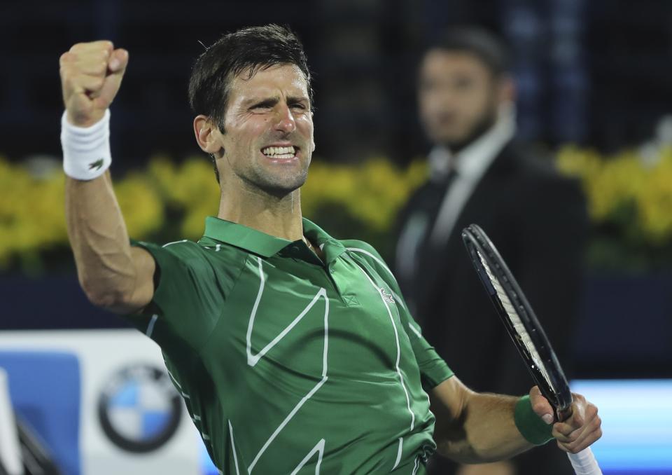 Serbia's Novak Djokovic celebrates after he beats Stefanos Tsitsipas of Greece in the final match of the Dubai Duty Free Tennis Championship in Dubai, United Arab Emirates, Saturday, Feb. 29, 2020. (AP Photo/Kamran Jebreili)