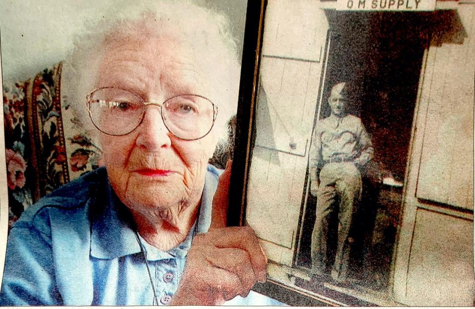 Mildred Waugh Edwards holds a picture of her brother Robert Waugh in this 2003 photo.
