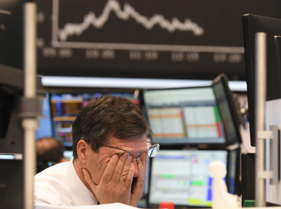 09 March 2020, Hessen, Frankfurt/Main: A stock trader rubs his eyes on the floor of the Frankfurt Stock Exchange. Stock exchanges around the world are reacting with huge losses to the fall in oil prices and concerns about the economic consequences of the coronavirus epidemic. Photo: Arne Dedert/dpa (Photo by Arne Dedert/picture alliance via Getty Images)