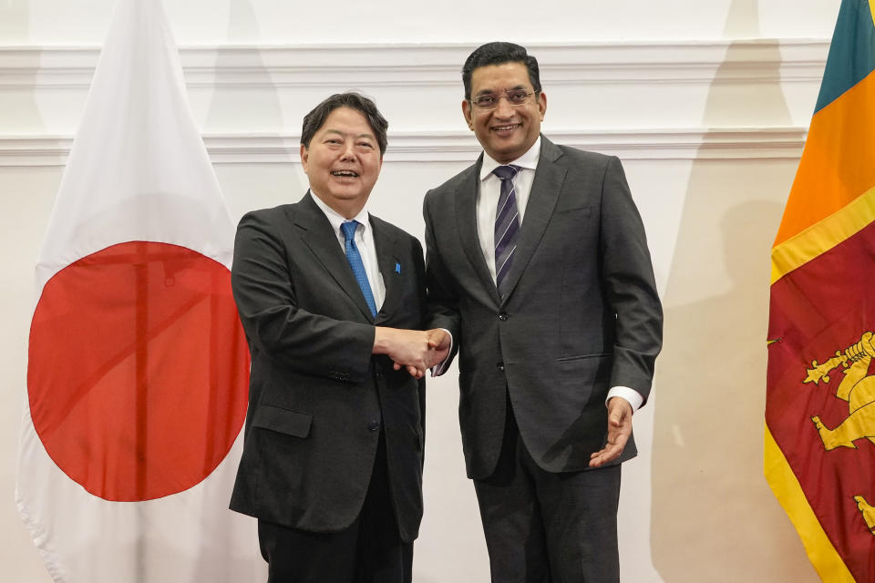 Japanese foreign minister Yoshimasa Hayashi, left, shakes hands with his Sri Lankan counterpart Ali Sabry after their meeting in Colombo, Sri Lanka on Saturday, July 29, 2023. (AP Photo/Eranga Jayawardena)