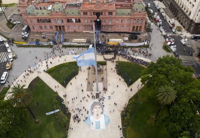 People line up to attend the wake of Diego Maradona at the presidential palace in Buenos Aires