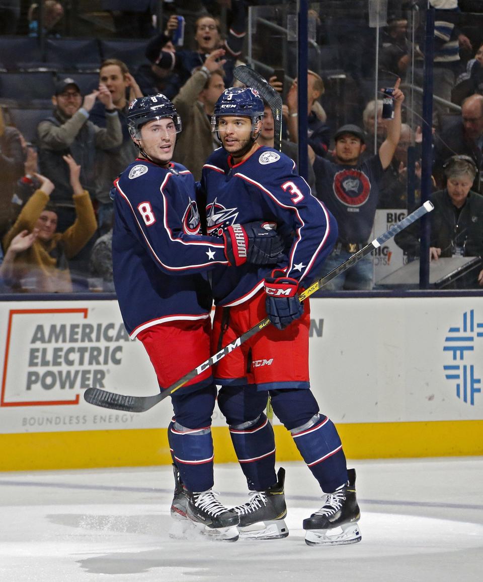 Blue Jackets defenseman Zach Werenski, left, celebrates his goal with Seth Jones against Dallas on Oct. 16, 2019.