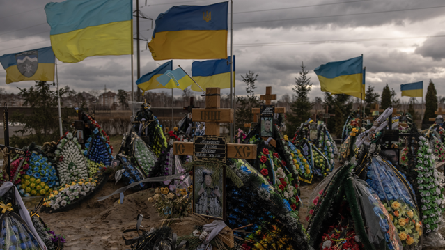 Ukrainian flags wave over the graves of Ukrainian soldiers killed during the Russian invas... (Roman Pilipey/Getty Images)