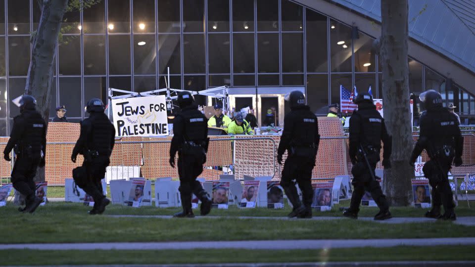 Police in riot gear walk past officers dismantling a pro-Palestinian encampment at MIT before dawn Friday in Cambridge, Massachusetts.<br />Josh Reynolds/AP - Josh Reynolds/AP