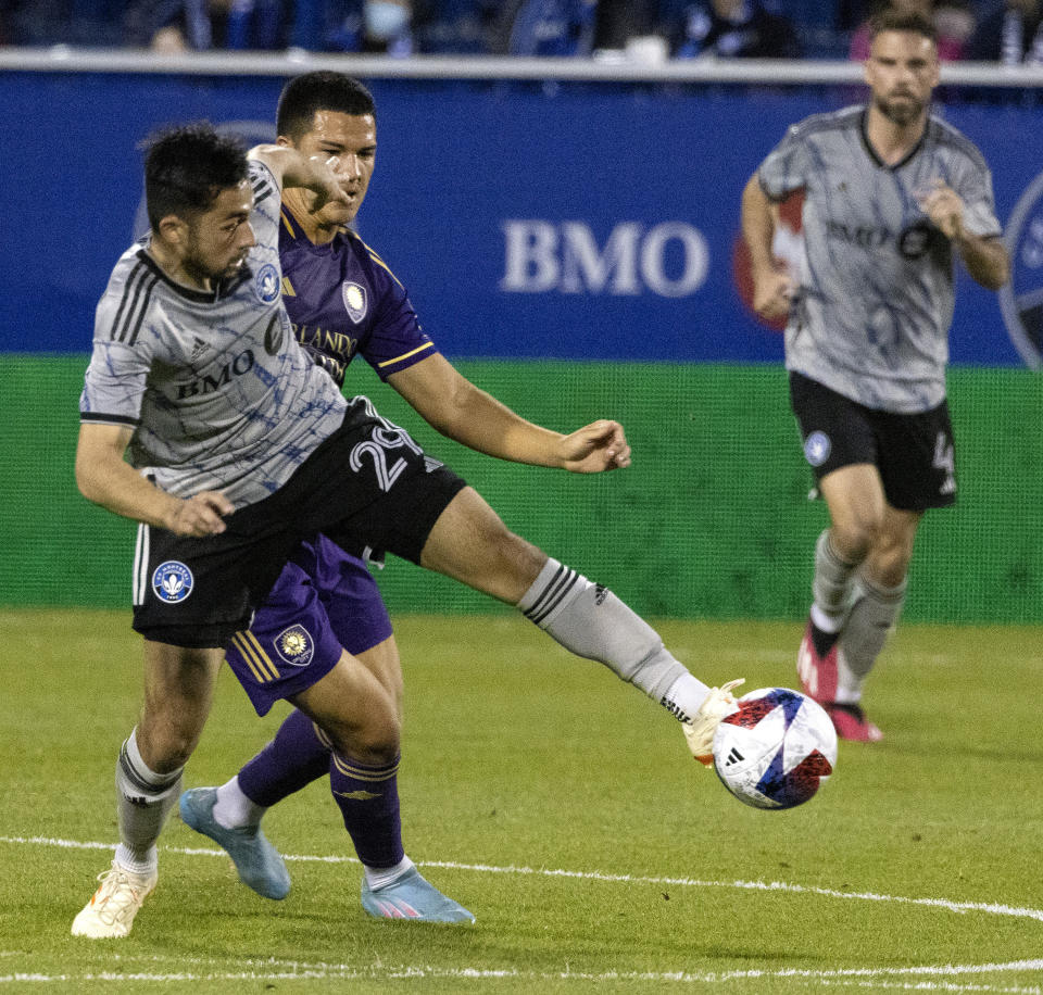 CF Montreal midfielder Mathieu Choiniere, left, battles with Orlando City midfielder Cesar Araujo during the first half of an MLS soccer game in Montreal, Saturday, May 6, 2023. (Allen McInnis/The Canadian Press via AP)