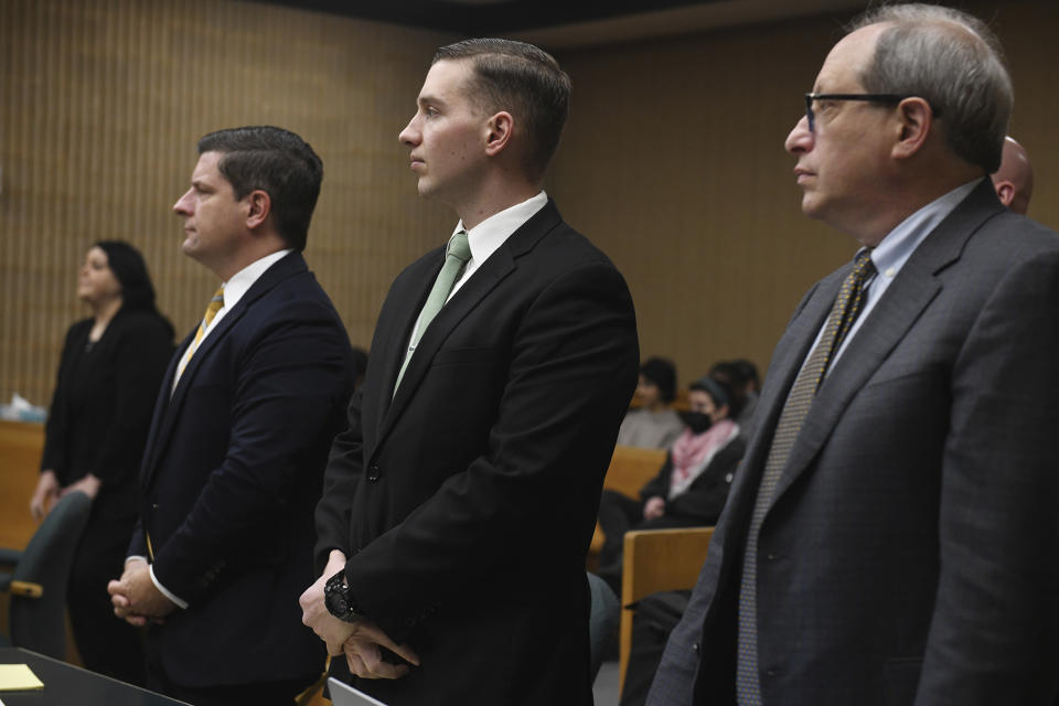 State Trooper Brian North, center, stands in Connecticut Superior Court at the start of the third day of jury deliberations for his trial in Milford, Conn., Friday, March 15, 2024. North was acquitted of all charges Friday in the death of Mubarak Soulemane, a community college student with mental illness who was shot as he sat behind the wheel of a stolen car holding a kitchen knife. (Ned Gerard/Hearst Connecticut Media via AP, Pool)