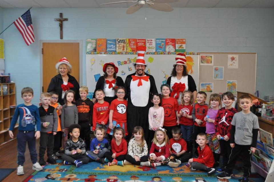 Jeff Contini, the Cat in the Hat, poses with his daughter Savannah’s pre-k class when he come in to read to the class.