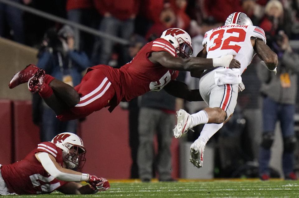 Ohio State running back TreVeyon Henderson is tackled by Wisconsin linebacker Maema Njongmeta after a long gain Saturday night at Camp Randall Stadium. Henderson rushed 24 times for 162 yards and ran 33 yards for the game’s final touchdown.