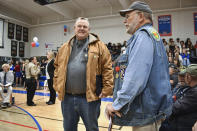 Sen. Jon Tester, D-Mont., speaks with a veteran at a Veterans Day event at Bigfork High School, on Nov. 10, 2023, in Bigfork, Mont. The Montana Democrat is seeking re-election to a fourth term. (AP Photo/Matthew Brown)