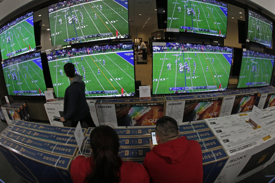 People shop for televisions at a Best Buy store during a Black Friday sale Thursday, Nov. 28, 2019, in Overland Park, Kan. (AP Photo/Charlie Riedel)