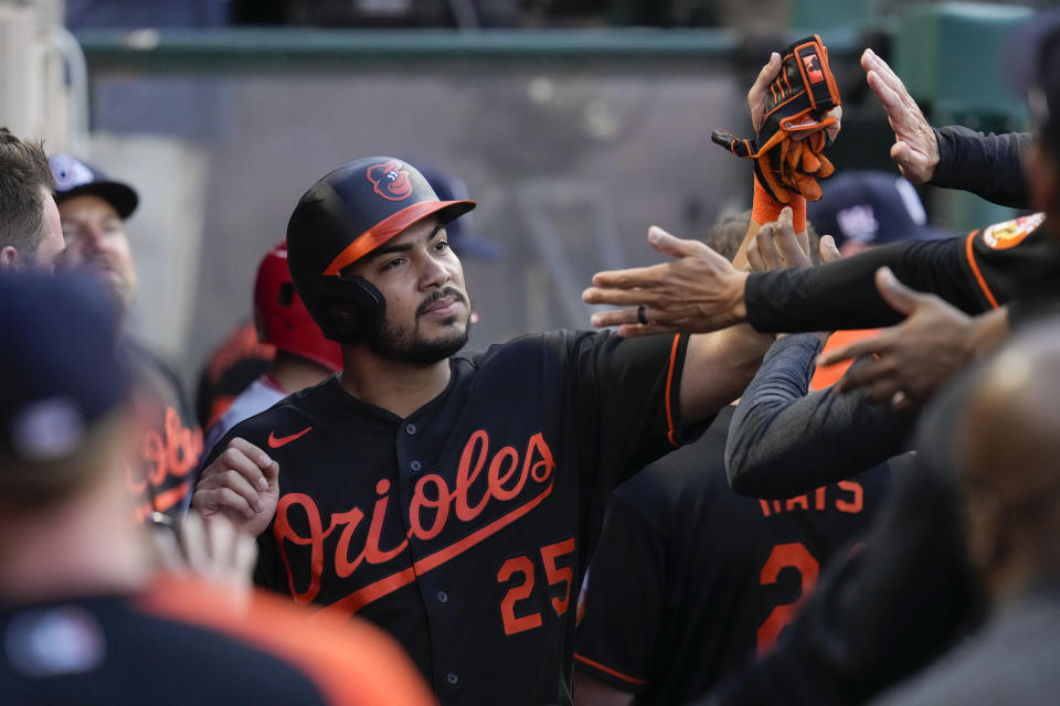 Baltimore Orioles' Anthony Santander (25) celebrates in the dugout with teammates after scoring during the third inning of a baseball game against the Los Angeles Angels Friday, July 2, 2021, in Anaheim. (AP Photo/Ashley Landis)