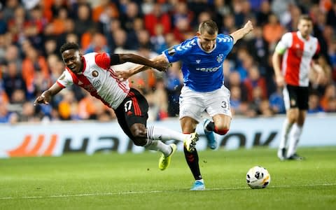 Luis Sinisterra of Feyenoord is bundled over by Borna Barisic of Rangers  - Credit: ROBERT PERRY/EPA-EFE/REX