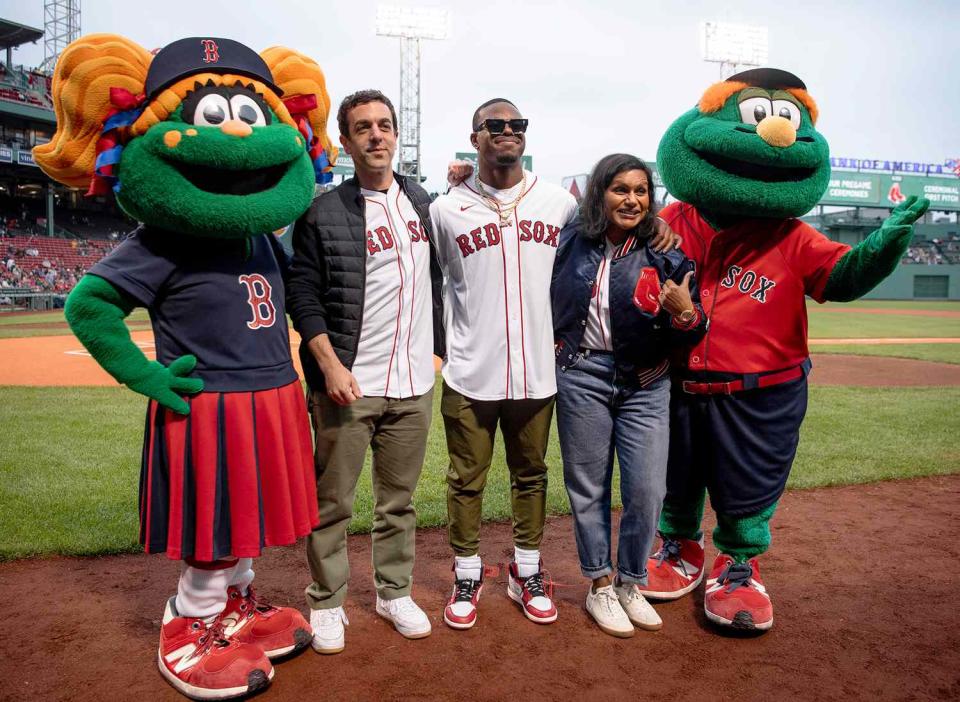 B.J. Novak, New England Patriots running back Damien Harris, and Mindy Kaling pose for a photo before a game between the Cincinnati Reds and the Boston Red Sox on June 1, 2022 at Fenway Park in Boston, Massachusetts