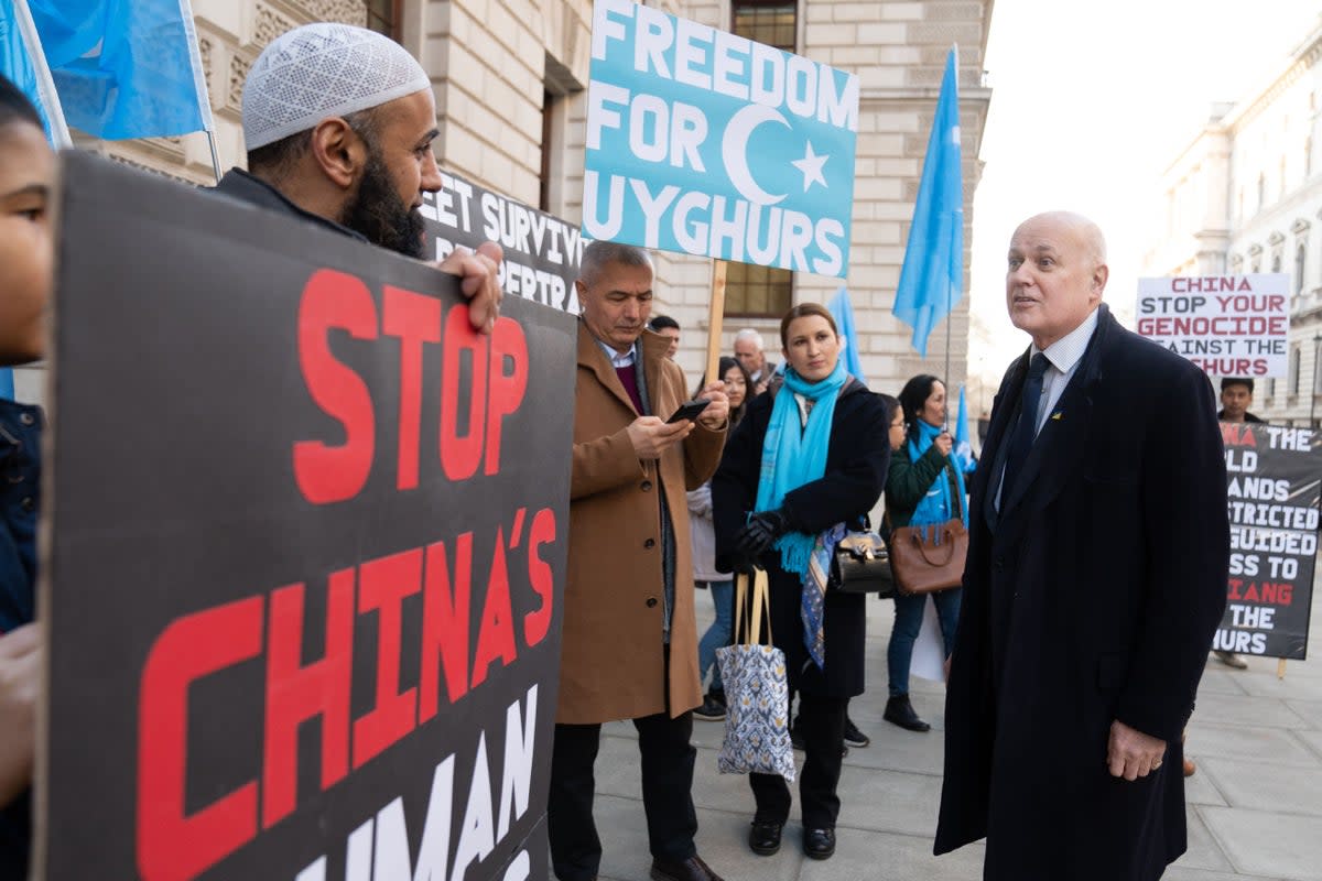 Sir Iain Duncan Smith (right) joins a vigil taking place outside the Foreign Office (PA)