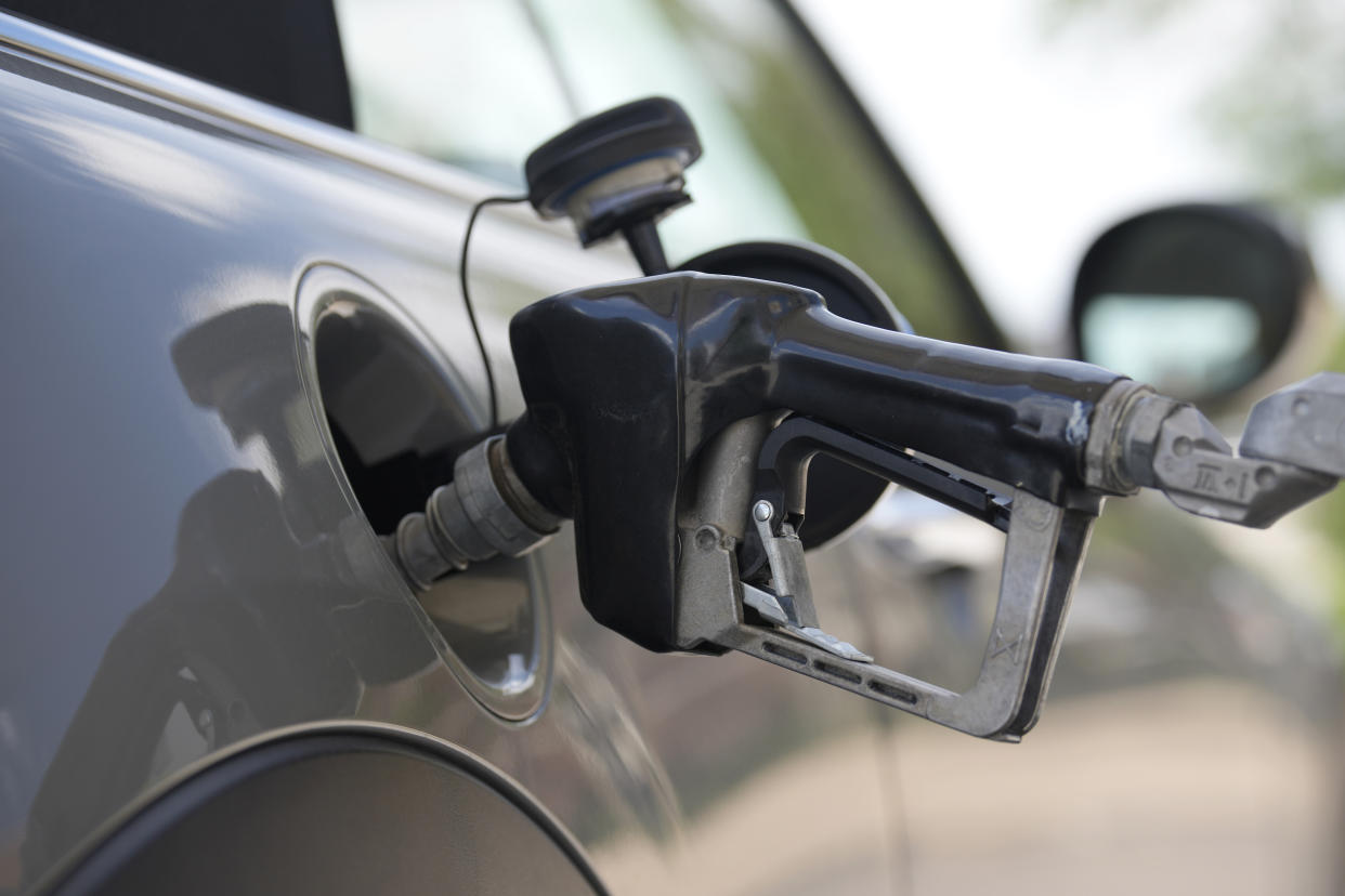 A car gets a refill at a gas station in Englewood, Colo. 