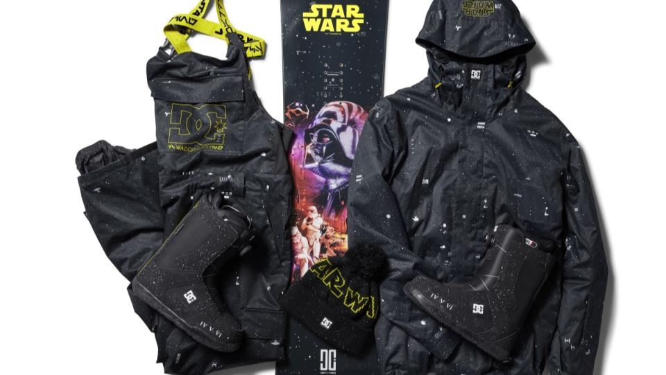 Star Wars snowboarding gear with black background, stars, and ships on a jacket, pants, boots, mittens, and snowboard