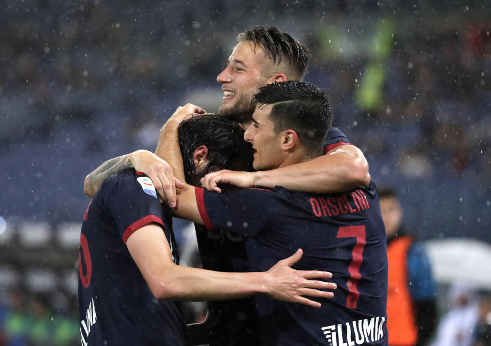 Bologna's Andrea Poli, left, celebrates with Bologna's Riccardo Orsolini after scoring his side's first goal during an Italian Serie A soccer match between Lazio and Bologna, at the Olympic stadium in Rome, Monday, May 20, 2019. (AP Photo/Andrew Medichini)