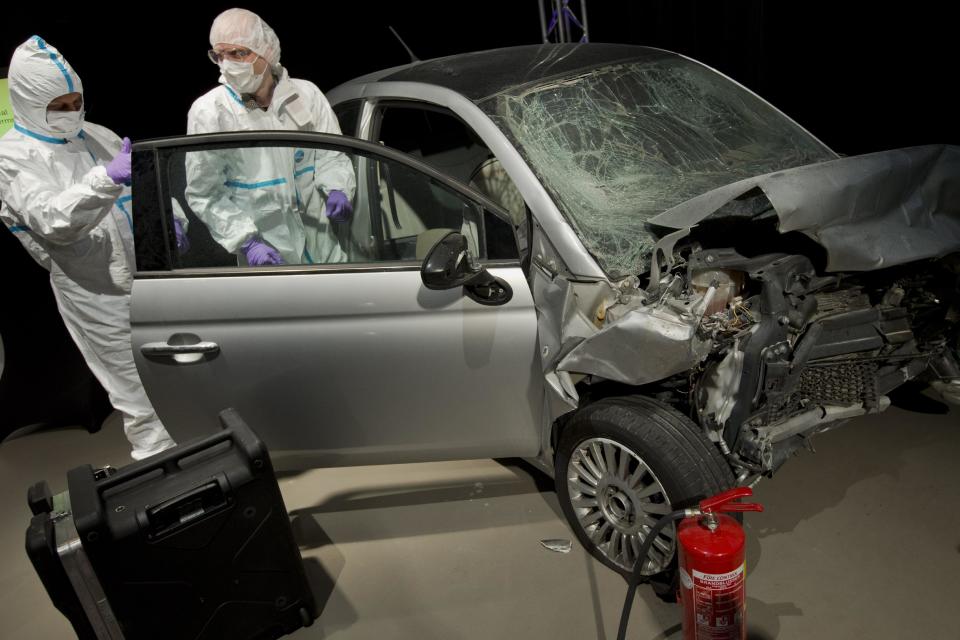 Experts with the Netherlands Forensic Institute NFI show how to secure evidence on a mock crime scene involving a dirty bomb, during a meeting on security technology ahead of the March 24 and 25 Nuclear Security Summit in The Hague Netherlands, Thursday, March 20, 2014. (AP Photo/Peter Dejong)