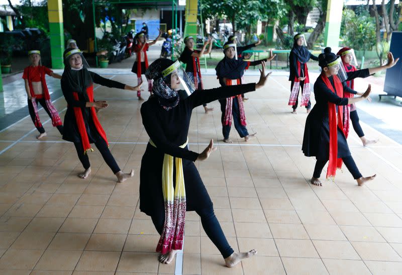 Traditional dancers wearing face shields perform as the government eases restrictions amid the coronavirus disease (COVID-19) outbreak in Tangerang, outskirts of Jakarta