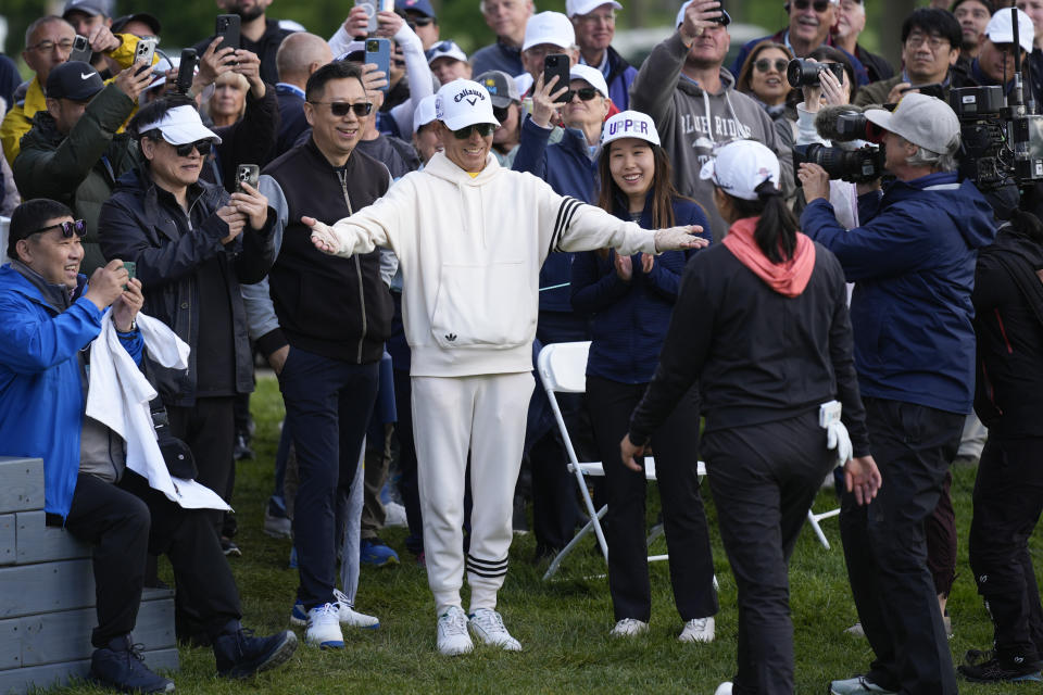 Haibin Zhang, center, greets his daughter Rose Zhang, front left, after she won the LPGA Cognizant Founders Cup golf tournament, Sunday, May 12, 2024, in Clifton, N.J. (AP Photo/Seth Wenig)