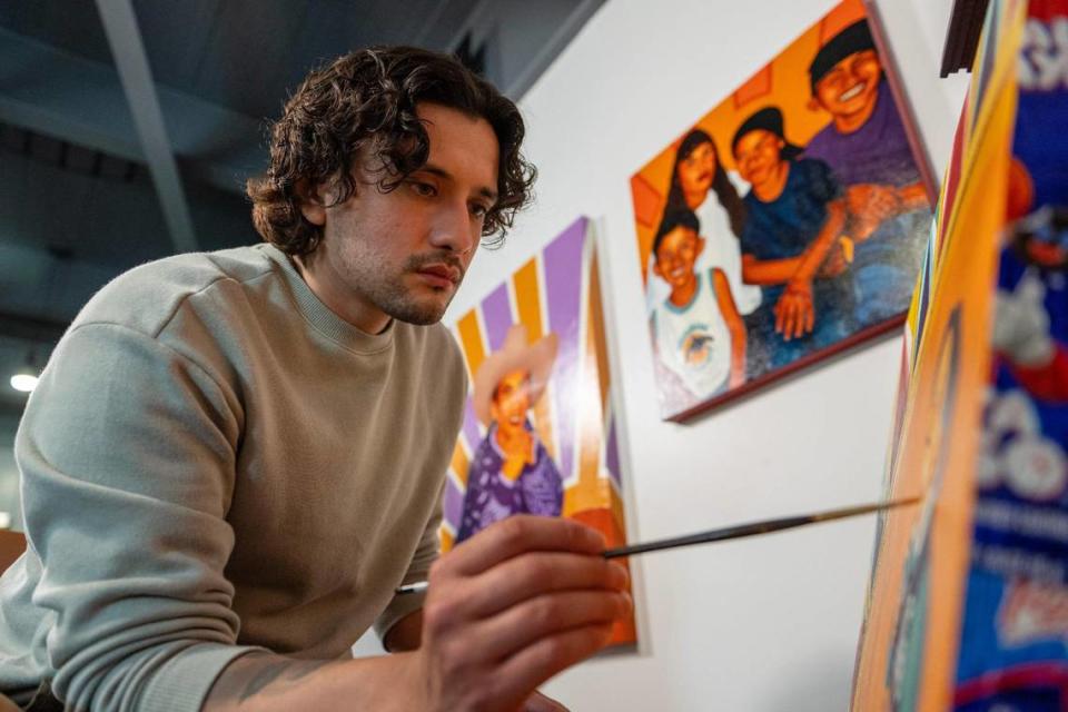 Cesar Velez puts the finishing touches on his painting “In Another Time” at his art studio. Emily Curiel/ecuriel@kcstar.com