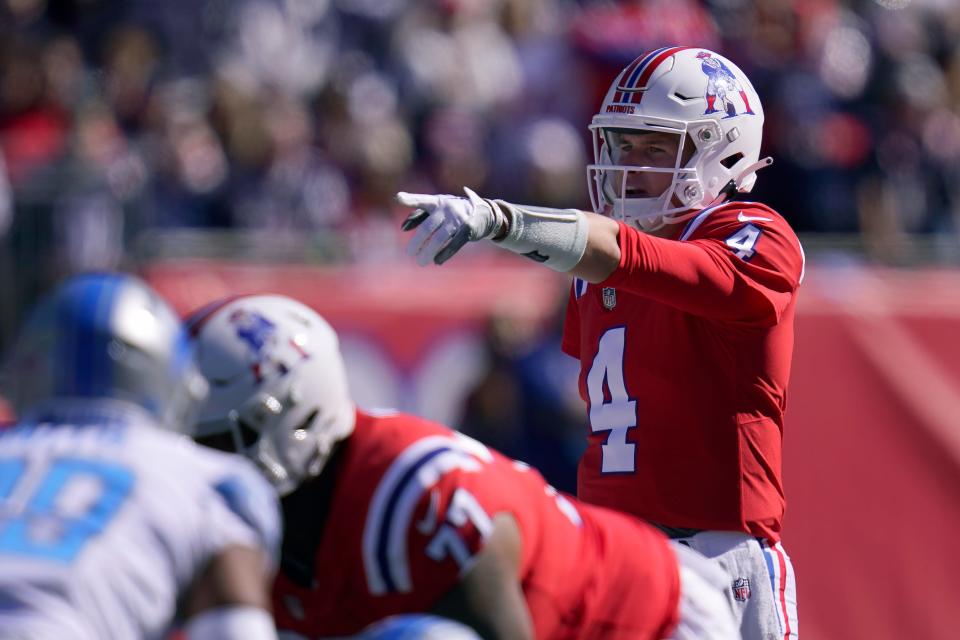 New England Patriots quarterback Bailey Zappe (4) gestures during the first half against the Detroit Lions, Sunday, Oct. 9, 2022, in Foxborough, Mass.