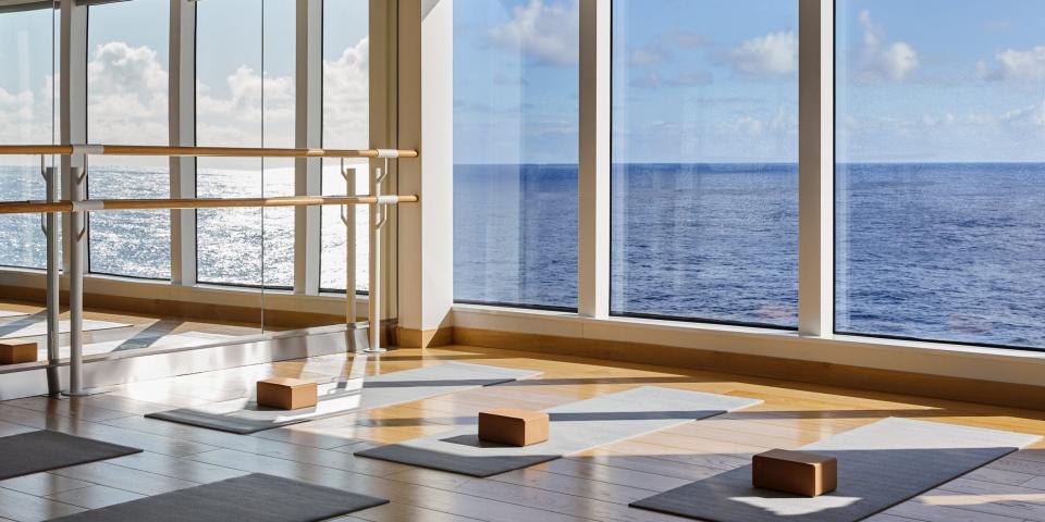 yoga mat and blocks in a room of windows and mirrors