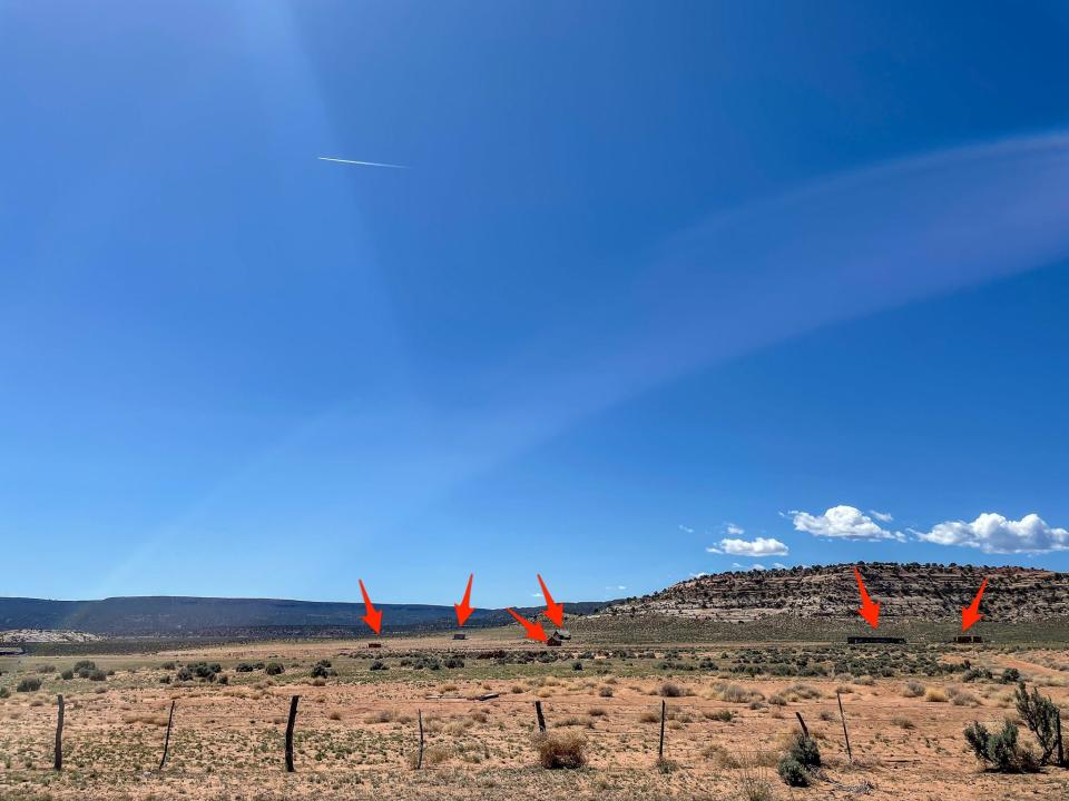 Arrows point to abandoned buildings that made up part of the ghost town.