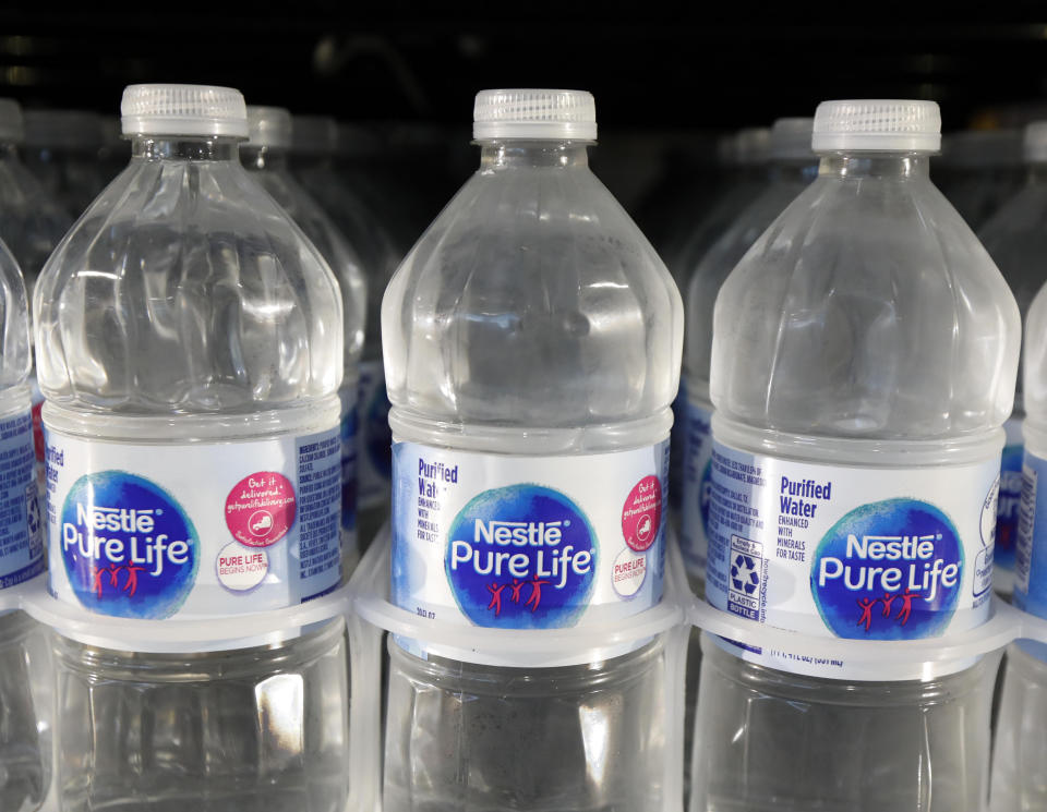 FILE - In this Sept. 21, 2018, file photo, is a closeup of pint bottles of purified water, Pure Life, manufactured by Nestle, on sale in a Ridgeland, Miss., convenience store. Global food giant Nestle is selling its North American bottled-water brands for $4.3 billion to a pair of private-equity firms that hope to reinvigorate sales. Brands including Poland Spring, Deer Park, Arrowhead and Pure Life will be sold to a subsidiary of One Rock Capital Partners in partnership with Metropoulos & Co. (AP Photo/Rogelio V. Solis, File)