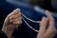 A woman holds a Rosary as a group prays during a rally outside of the Baltimore hotel where the United States Conference of Catholic Bishops are holding its Fall General Assembly meeting, Tuesday, Nov. 16, 2021, in Baltimore. (AP Photo/Julio Cortez)