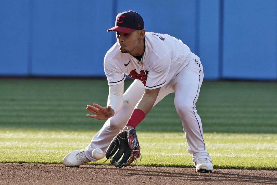 Cleveland Indians' Andres Gimenez fields a ball hit by Cincinnati Reds' Tyler Stephenson, who was out at first during the fourth inning of a baseball game Saturday, May 8, 2021, in Cleveland. (AP Photo/Tony Dejak)