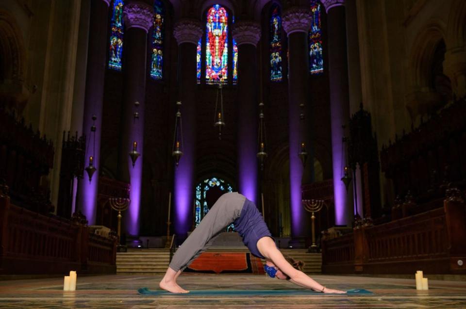 Mia Michelson-Bartlett, yoga teacher and manager of visitors’ services, practices yoga and mindfulness meditation inside the Cathedral of St. John the Divine in New York City. <a href="https://www.gettyimages.com/detail/news-photo/mia-michelson-bartlett-yoga-teacher-and-cathedral-manager-news-photo/1231935869?phrase=mindfulness%20&adppopup=true" rel="nofollow noopener" target="_blank" data-ylk="slk:Angela Weiss/AFP via Getty Images;elm:context_link;itc:0;sec:content-canvas" class="link ">Angela Weiss/AFP via Getty Images</a>