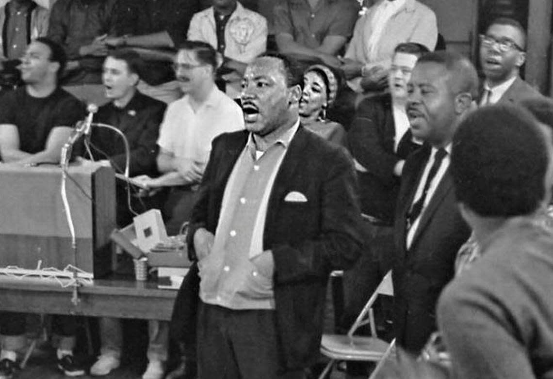 Martin Luther King Jr. sings, center, at a Southern Christian Leadership Conference staff workshop held at the Penn Center on St. Helena Island in 1966.