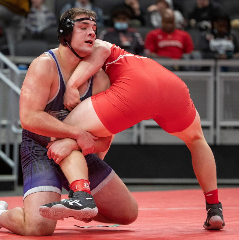 Leighton Jones of Brownsburg High School (left), winner of this 285 pound match, controls Liam Begley of Crown Point High School, at Indianapolis’ Gainbridge Fieldhouse, Friday, Feb. 18, 2022, during the preliminary round of the IHSAA wrestling state finals. 